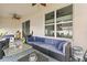 Covered patio featuring comfortable seating, ceiling fans, and nice view into the backyard at 944 Old Windsor Way, Spring Hill, FL 34609