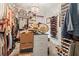 Organized walk-in closet with custom shelving, ample storage for clothing and accessories, and a stylish chandelier at 944 Old Windsor Way, Spring Hill, FL 34609