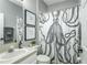 Elegant bathroom featuring vanity, toilet, stylish octopus shower curtain, and decorative wall art at 9608 Greenpointe Dr, Tampa, FL 33626