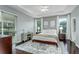 Cozy bedroom with tray ceiling, neutral decor, and lots of natural light at 9608 Greenpointe Dr, Tampa, FL 33626