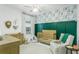Charming Bedroom with green accent wall, crib, neutral tones and fun, animal-themed wallpaper at 9608 Greenpointe Dr, Tampa, FL 33626