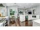 Bright kitchen boasts a center island, modern appliances, sleek white cabinets, and leads to the outdoor patio at 9608 Greenpointe Dr, Tampa, FL 33626