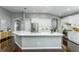 Stylish kitchen features white cabinetry, stainless steel appliances, and sleek counter tops at 9608 Greenpointe Dr, Tampa, FL 33626