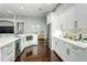 A bright, open kitchen features modern appliances, white cabinetry, and stylish hardware, adding elegance at 9608 Greenpointe Dr, Tampa, FL 33626