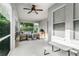 Relaxing covered patio features comfortable seating, ceiling fan and outdoor grill, perfect for entertaining at 9608 Greenpointe Dr, Tampa, FL 33626