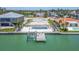 Aerial view of a waterfront property featuring a pool and dock, showcasing coastal living at 10126 Tarpon Dr, Treasure Island, FL 33706