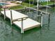 Dock featuring sturdy pillars and a boat lift, offering easy access to the water at 10126 Tarpon Dr, Treasure Island, FL 33706