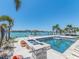Waterfront pool area with in-ground pool offering stunning views of the inter-coastal waterway at 10126 Tarpon Dr, Treasure Island, FL 33706
