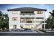 Stunning rear exterior of a three-story home with balconies overlooking a pool and waterfront at 10126 Tarpon Dr, Treasure Island, FL 33706
