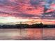 Beautiful sunset view of the water reflecting the colors from the clouds at 10126 Tarpon Dr, Treasure Island, FL 33706