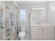 Freshly painted bathroom offers a toilet, vanity with white counter, and shower with decorative curtain at 10446 Baylor Dr, Spring Hill, FL 34608