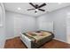 This bedroom features a ceiling fan, wood floors, closet, and a queen size bed at 10446 Baylor Dr, Spring Hill, FL 34608