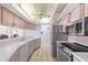 Quaint kitchen with stainless steel appliances and overhead lighting at 10446 Baylor Dr, Spring Hill, FL 34608