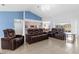 Bright and open living room with tile floors, high ceilings, and comfortable seating at 10446 Baylor Dr, Spring Hill, FL 34608