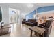 Open-concept living room featuring tile flooring, high ceilings, and stylish furniture at 10446 Baylor Dr, Spring Hill, FL 34608