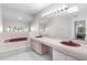 Bright main bathroom with double sink vanity, walk-in shower and tub at 10446 Baylor Dr, Spring Hill, FL 34608