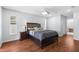 Spacious main bedroom featuring wood floors, ceiling fan, and large window for natural light at 10446 Baylor Dr, Spring Hill, FL 34608