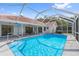 Relaxing screened-in pool area, featuring crystal-clear water and ample space for lounging in the Florida sun at 10446 Baylor Dr, Spring Hill, FL 34608