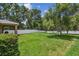 Large backyard featuring lush lawn, privacy fence, and shade trees; perfect for outdoor activities at 10512 Scenic Hollow Dr, Riverview, FL 33578