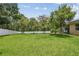 Spacious backyard with well-kept lawn, privacy fence, and mature trees for shade at 10512 Scenic Hollow Dr, Riverview, FL 33578