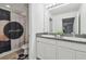 Bathroom featuring double sink vanity with granite counters, decorative shower curtain and neutral tones at 10512 Scenic Hollow Dr, Riverview, FL 33578
