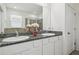 Bright bathroom with double sinks, granite countertop, and walk-in shower featuring glass door at 10512 Scenic Hollow Dr, Riverview, FL 33578