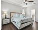Bedroom featuring hardwood floors and modern furniture at 10512 Scenic Hollow Dr, Riverview, FL 33578