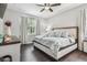 Primary bedroom featuring a ceiling fan and hardwood floors at 10512 Scenic Hollow Dr, Riverview, FL 33578