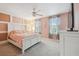 Light primary bedroom featuring pink walls, carpet, and windows with lots of natural light at 10512 Scenic Hollow Dr, Riverview, FL 33578
