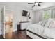 Cozy Primary bedroom featuring a ceiling fan and hardwood floors at 10512 Scenic Hollow Dr, Riverview, FL 33578