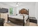 Primary bedroom featuring a decorative wood bed frame, carpet, and television on dresser at 10512 Scenic Hollow Dr, Riverview, FL 33578