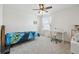 Bright bedroom with ceiling fan, carpet, and desk area for study and office work at 10512 Scenic Hollow Dr, Riverview, FL 33578