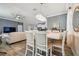 Open-concept dining and kitchen with tile floors and modern furnishings at 10512 Scenic Hollow Dr, Riverview, FL 33578