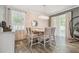 Dining area with modern chandelier, sheer curtains, and neutral wall paint at 10512 Scenic Hollow Dr, Riverview, FL 33578