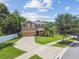 Inviting two-story home with a well-manicured lawn, mature trees, and a spacious driveway leading to an attached garage at 10512 Scenic Hollow Dr, Riverview, FL 33578