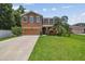 Charming two-story home with a well-manicured lawn and a two car garage at 10512 Scenic Hollow Dr, Riverview, FL 33578