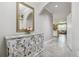 Bright Foyer with decorative mirror, console table and tile floors at 10512 Scenic Hollow Dr, Riverview, FL 33578