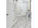 Hallway features tile floors, a console table with mirror, and access to the kitchen at 10512 Scenic Hollow Dr, Riverview, FL 33578