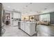 Open concept kitchen with island seating, stainless steel appliances and view to living room at 10512 Scenic Hollow Dr, Riverview, FL 33578