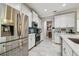 Modern kitchen with stainless steel appliances, white cabinetry, tile floors, and accent backsplash at 10512 Scenic Hollow Dr, Riverview, FL 33578