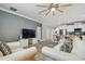 Open-concept living room, with view into the kitchen, white sofa, and modern fan at 10512 Scenic Hollow Dr, Riverview, FL 33578