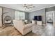 Bright living room with a hanging chair, sofa, modern fan, and tile flooring at 10512 Scenic Hollow Dr, Riverview, FL 33578