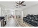 Bright, open living room featuring hard wood floors, sofa, and multiple areas for activities at 10512 Scenic Hollow Dr, Riverview, FL 33578