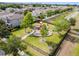 Community playground featuring colorful equipment, mature shade trees, and green lawns in a fenced area at 10512 Scenic Hollow Dr, Riverview, FL 33578