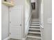 Stairway with wood and white trim plus art detail and tile flooring, plus shelf detail at 10512 Scenic Hollow Dr, Riverview, FL 33578