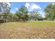 Sprawling backyard with partial fencing and mature trees at 12412 Lakeview Dr, Dade City, FL 33525