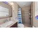 Bathroom featuring a shower and vanity sink with granite countertops at 12412 Lakeview Dr, Dade City, FL 33525