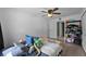 Bedroom featuring ceiling fan, closet and laminate wood flooring at 12412 Lakeview Dr, Dade City, FL 33525