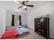Bedroom featuring laminate flooring, window, and closet at 12412 Lakeview Dr, Dade City, FL 33525
