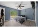Bedroom with sliding glass doors, wood-look floors, and a ceiling fan at 12412 Lakeview Dr, Dade City, FL 33525